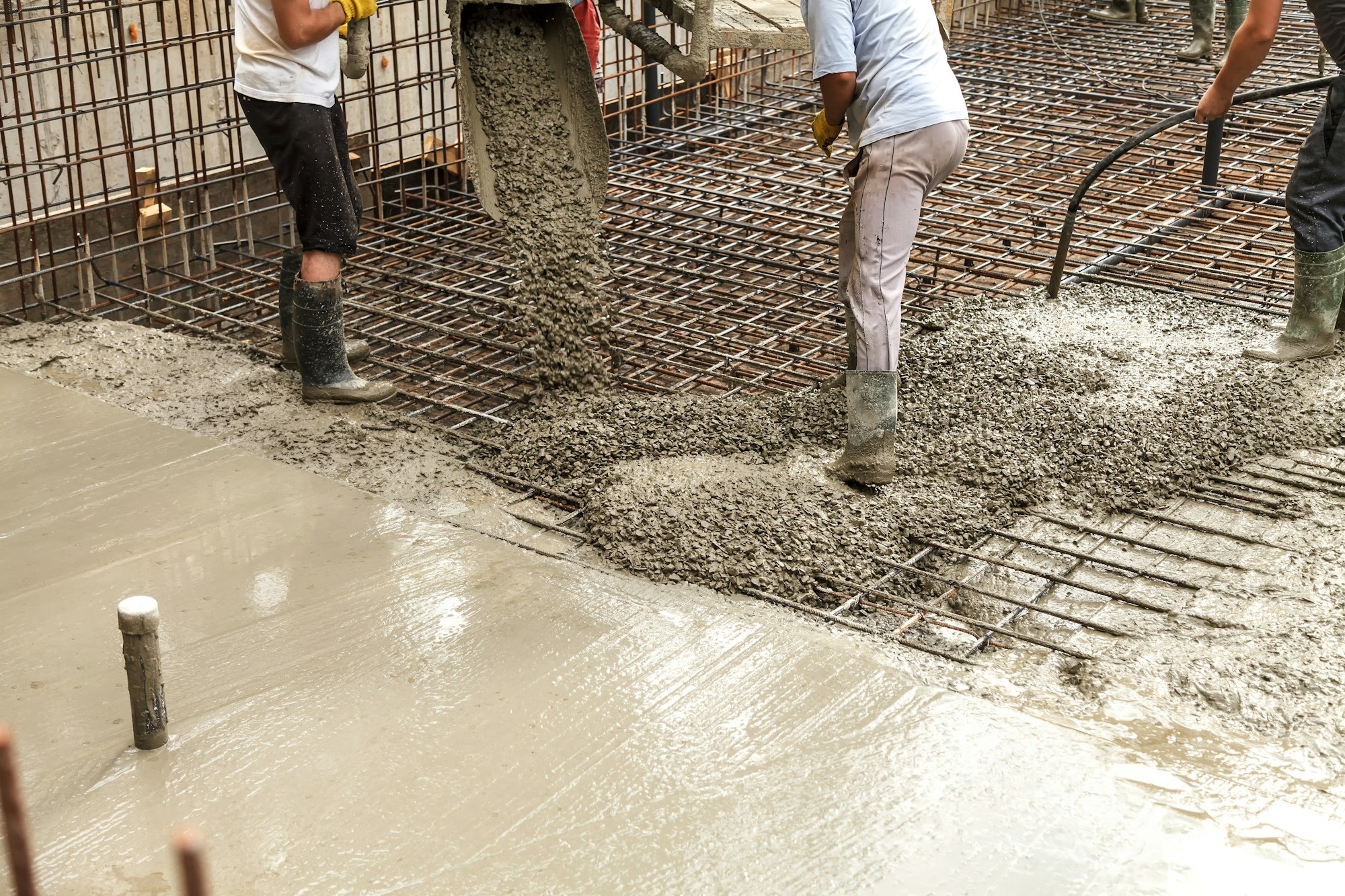 Pouring concrete into the construction of the house. Builders are pouring ready-mixed concrete